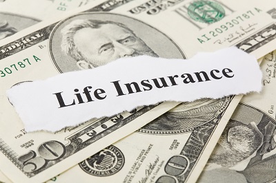 image of life insurance sign on pile of money