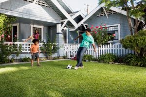 people playing soccer in the backyard